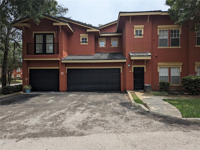 view of front of property with a balcony and a garage