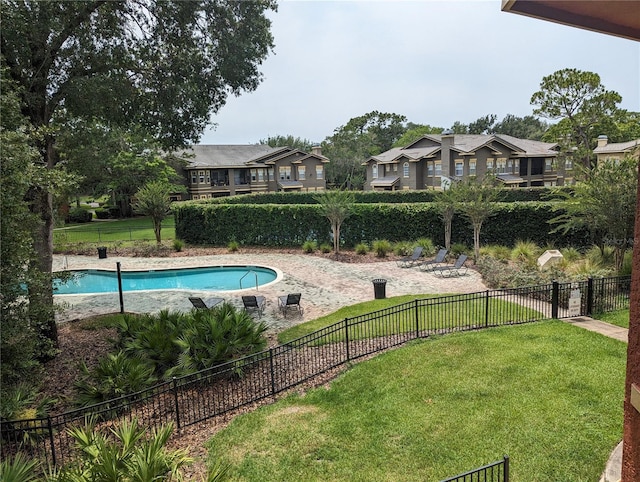 view of pool featuring a lawn