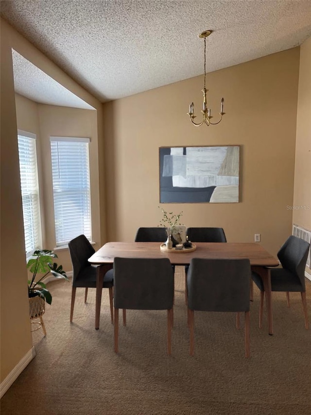 dining room featuring carpet floors, vaulted ceiling, a textured ceiling, and an inviting chandelier