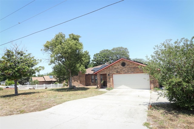 view of front of home with a front yard and solar panels