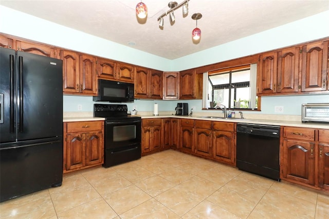 kitchen with black appliances, light tile patterned flooring, sink, and a textured ceiling