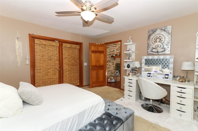 carpeted bedroom featuring ceiling fan and a closet