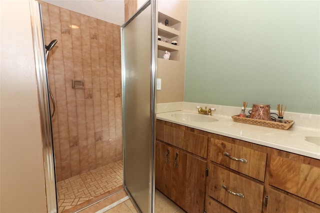 bathroom featuring tile patterned flooring, vanity, and an enclosed shower