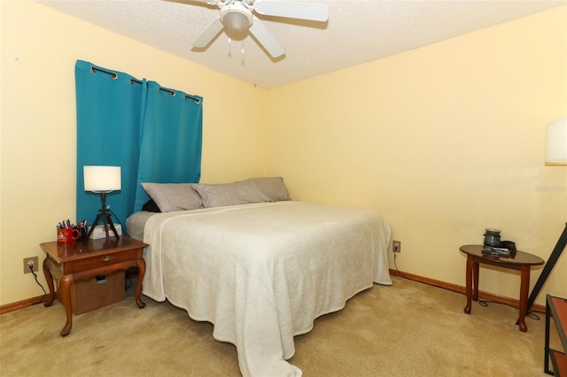 carpeted bedroom with a textured ceiling and ceiling fan