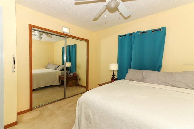 bedroom with ceiling fan, a closet, and a textured ceiling