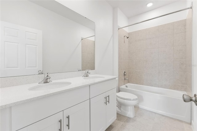 full bathroom with tiled shower / bath combo, tile patterned flooring, vanity, and toilet