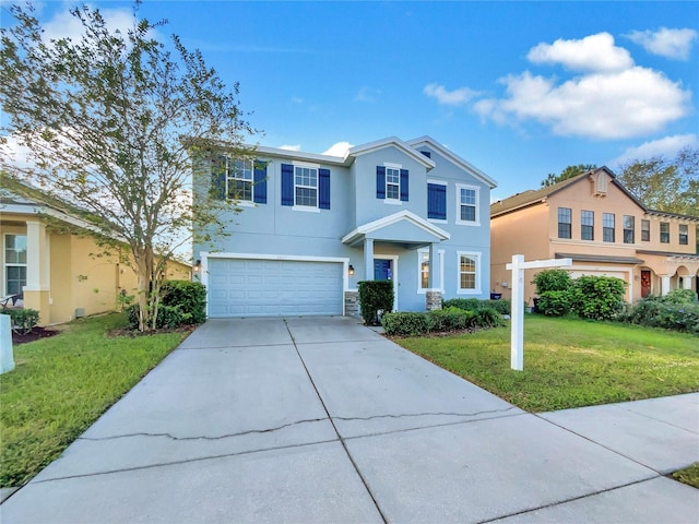 view of front of home with a garage and a front lawn