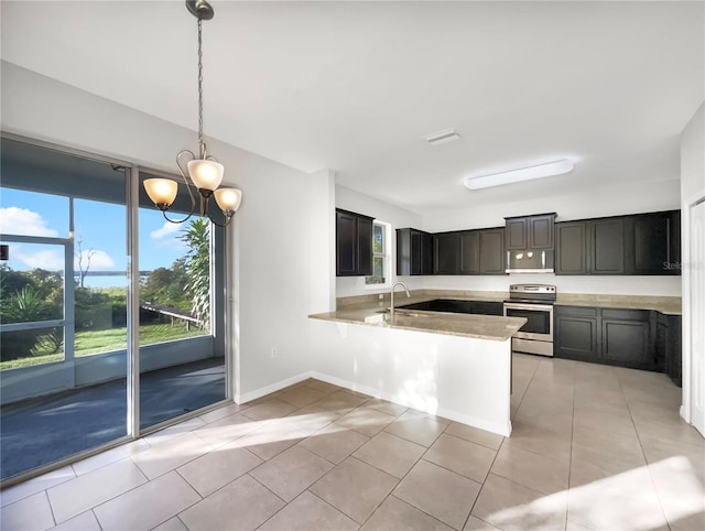 kitchen with kitchen peninsula, plenty of natural light, stainless steel appliances, and decorative light fixtures