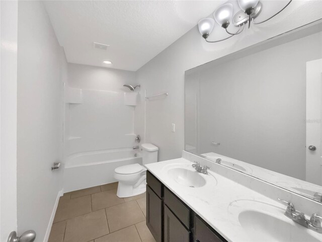 full bathroom with tile patterned floors, vanity, shower / bath combination, and toilet