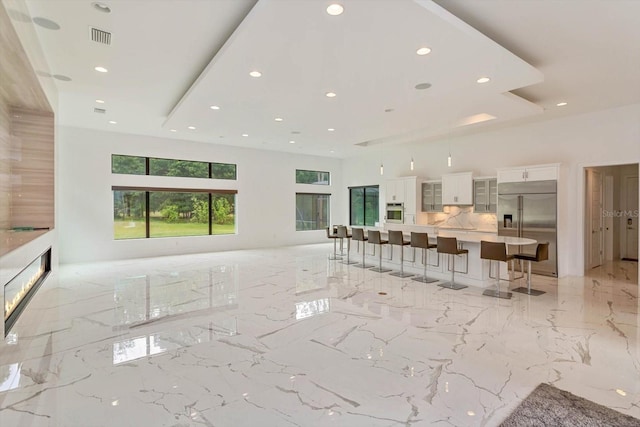 unfurnished living room with light tile floors