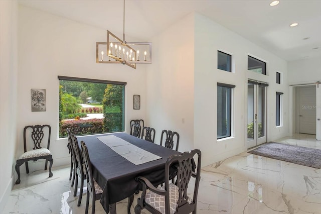 tiled dining area featuring high vaulted ceiling and a chandelier