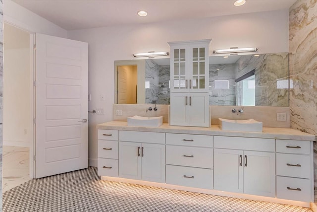 bathroom with tile floors and dual bowl vanity