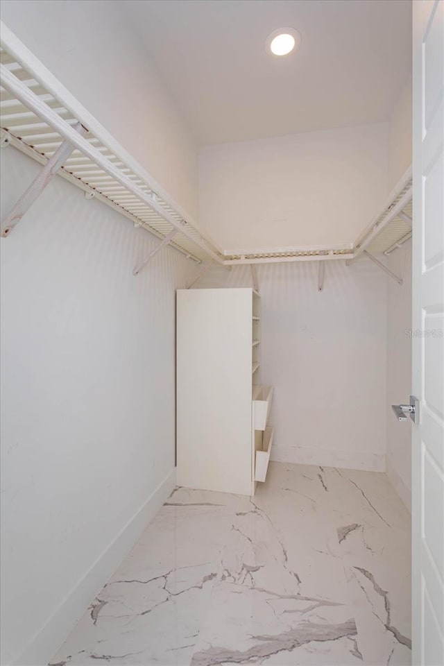 spacious closet with tile flooring