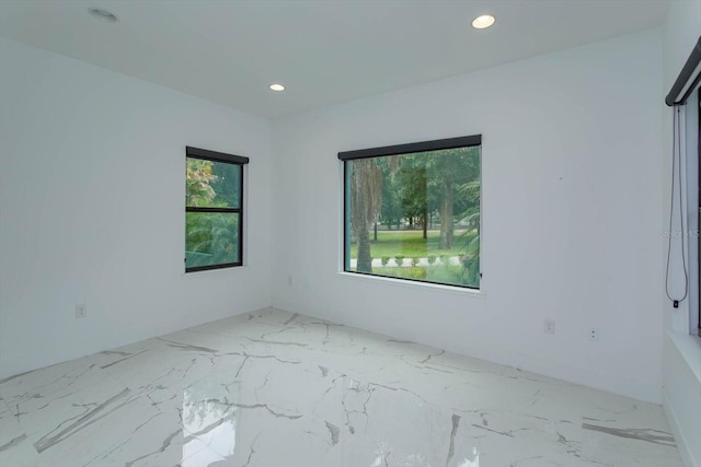 unfurnished room featuring plenty of natural light