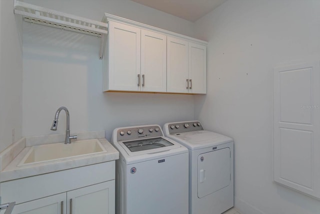 laundry room featuring sink, separate washer and dryer, and cabinets