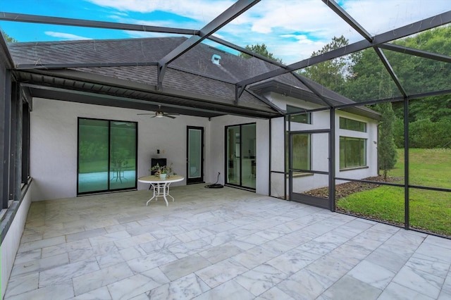 unfurnished sunroom featuring ceiling fan