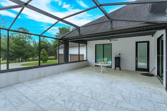 unfurnished sunroom with ceiling fan