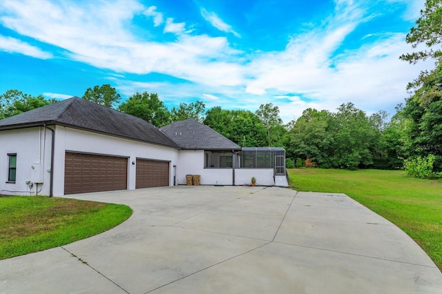 view of home's exterior featuring a garage and a lawn