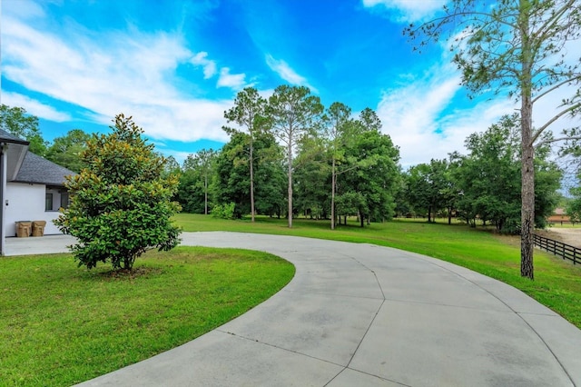 view of home's community featuring a lawn