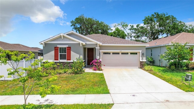 view of front of property featuring a garage and a front lawn