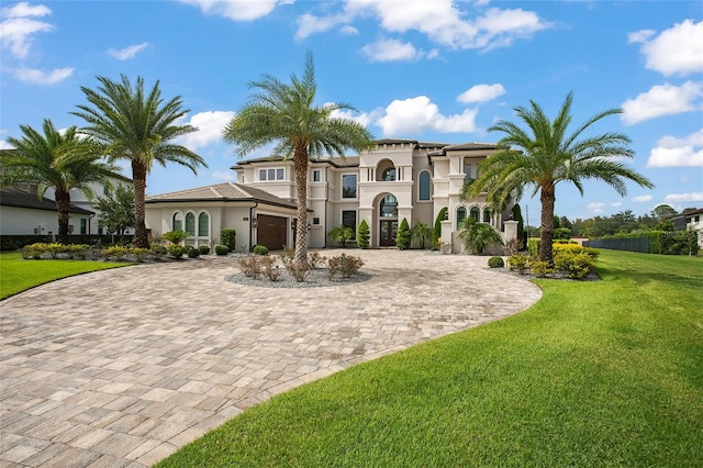 mediterranean / spanish-style house with a front lawn and a garage