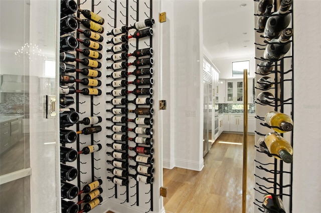 wine room featuring light hardwood / wood-style flooring and ornamental molding