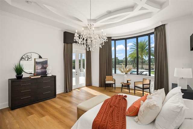 bedroom featuring a water view, crown molding, access to exterior, light wood-type flooring, and a notable chandelier