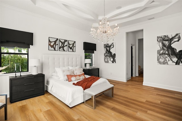 bedroom featuring a notable chandelier, a raised ceiling, wood-type flooring, and ornamental molding