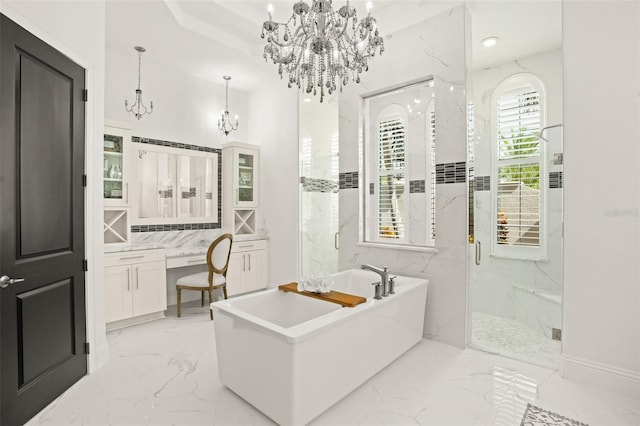 bathroom with vanity and shower with separate bathtub