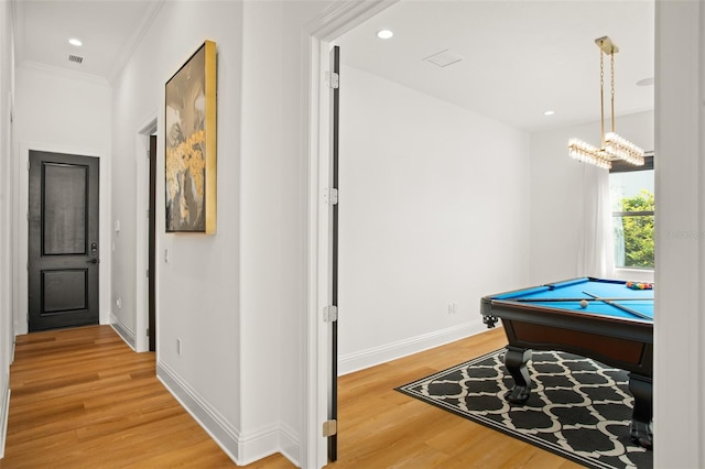 game room with a chandelier, hardwood / wood-style floors, crown molding, and billiards