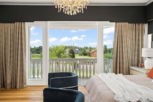 bedroom with wood-type flooring and an inviting chandelier