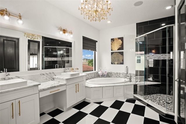 bathroom featuring vanity, independent shower and bath, and a chandelier