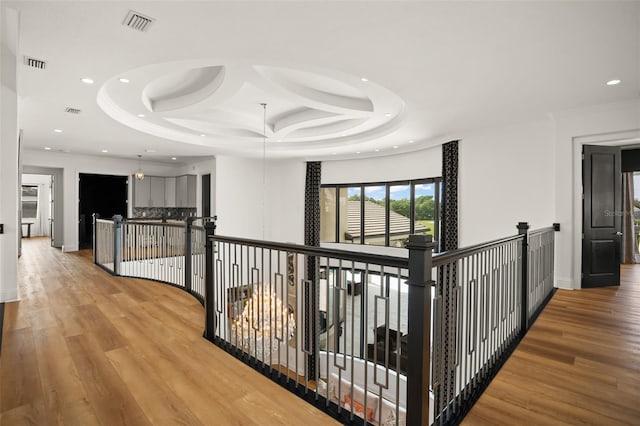 hall with light hardwood / wood-style flooring and ornamental molding