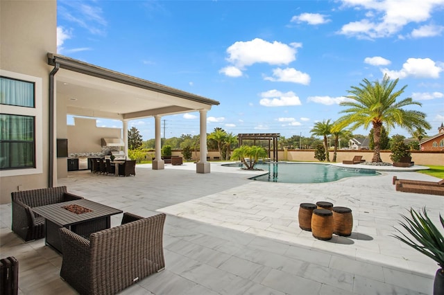 view of pool with an outdoor living space with a fire pit and a patio