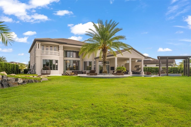 rear view of property with a lawn, a pergola, an outdoor living space, a balcony, and a patio area