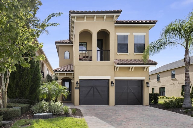 mediterranean / spanish house featuring a garage and a balcony