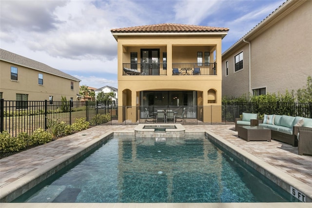 view of swimming pool featuring a patio, outdoor lounge area, and an in ground hot tub