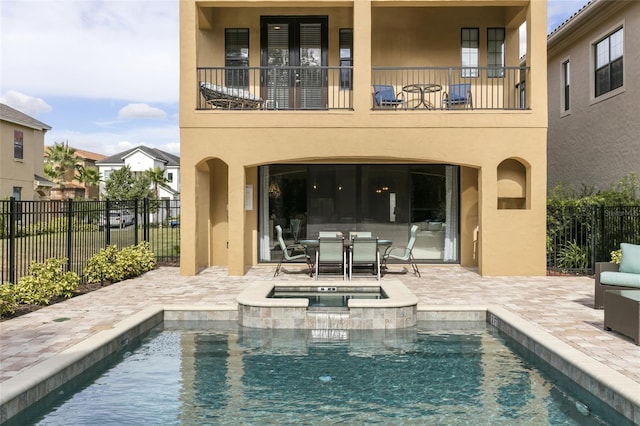 view of swimming pool featuring a patio area and an in ground hot tub