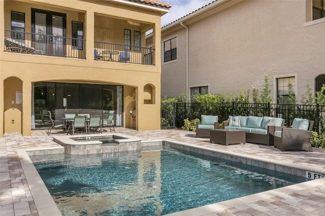 view of swimming pool featuring a patio area, an outdoor living space, and an in ground hot tub