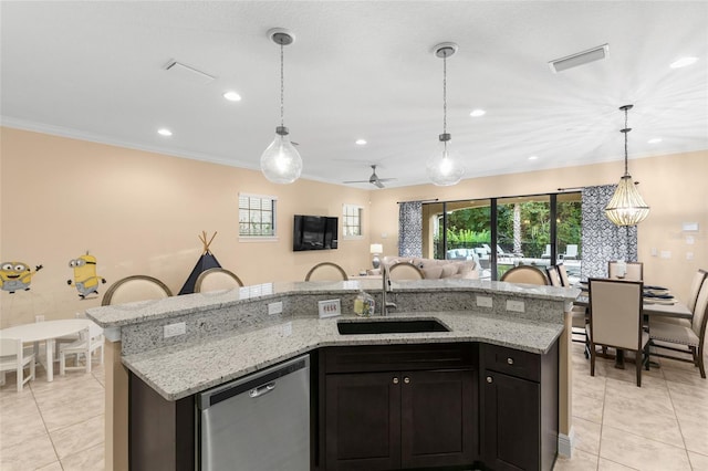 kitchen featuring decorative light fixtures, light tile flooring, and stainless steel dishwasher