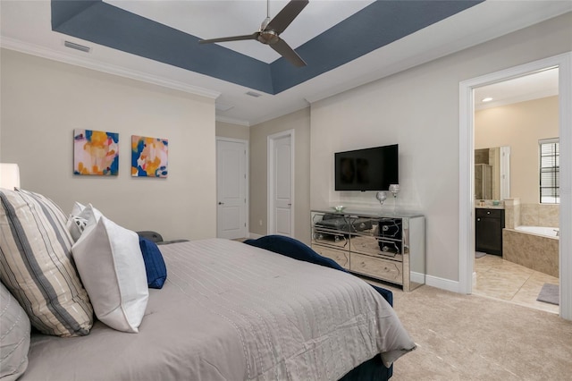 bedroom with carpet, ensuite bathroom, ceiling fan, a raised ceiling, and ornamental molding