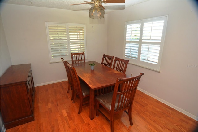 dining area featuring hardwood / wood-style flooring and ceiling fan