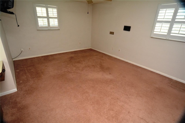 empty room with plenty of natural light and carpet