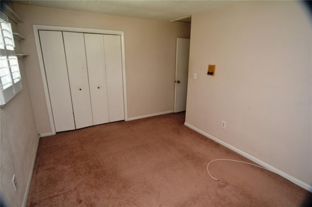 unfurnished bedroom featuring a closet and carpet flooring