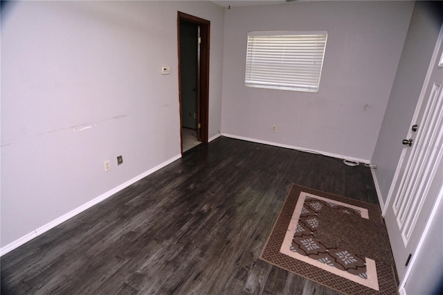 spare room with dark hardwood / wood-style flooring