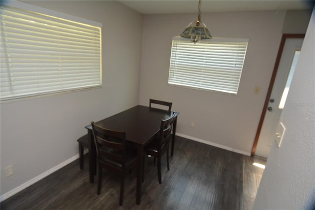 dining area featuring dark wood-type flooring