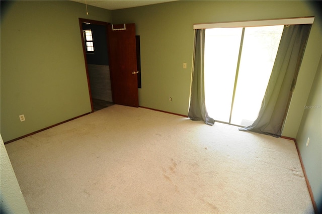 carpeted empty room with a wealth of natural light