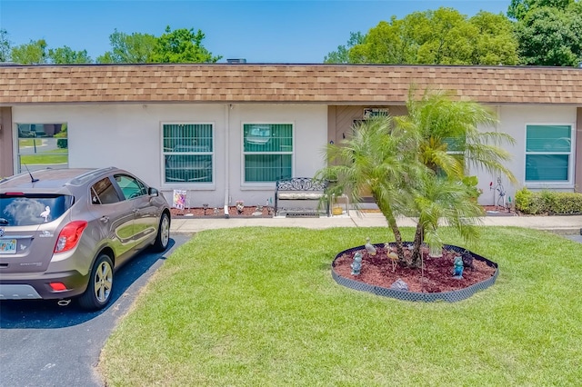 ranch-style home with a front lawn