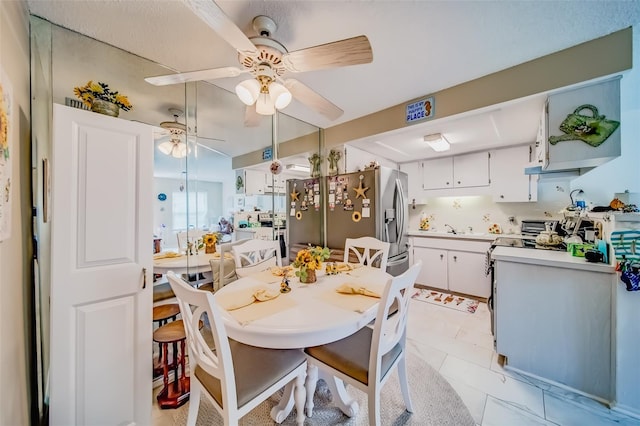 kitchen featuring white cabinets and stainless steel fridge