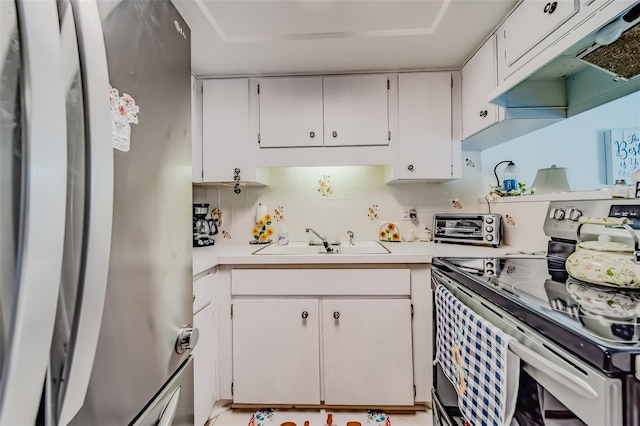 kitchen with white cabinets, sink, appliances with stainless steel finishes, and tasteful backsplash